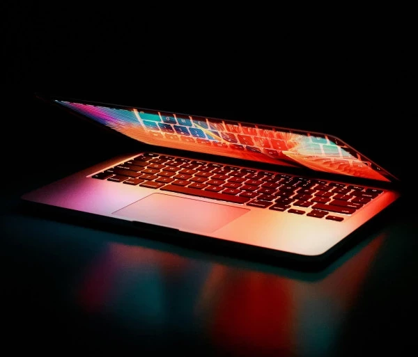 Semi opened laptop computer turned on on table